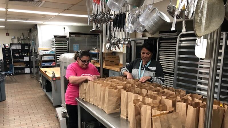 Sheridan staff prepare grab-and-go meals for students during school closures.
