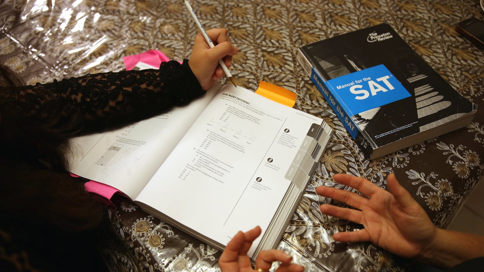 Carol McMullen-Pettit, a Premier Tutor at The Princeton Review, goes over SAT test preparation with 11th grader, Suzane Nazir,  on March 6, 2014 in Pembroke Pines, Florida. (Photo by Joe Raedle/Getty Images)
