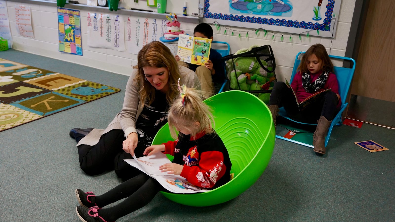 Teacher Kimberly Meyers reads with a first grader at School 46 in Indianapolis Public Schools.