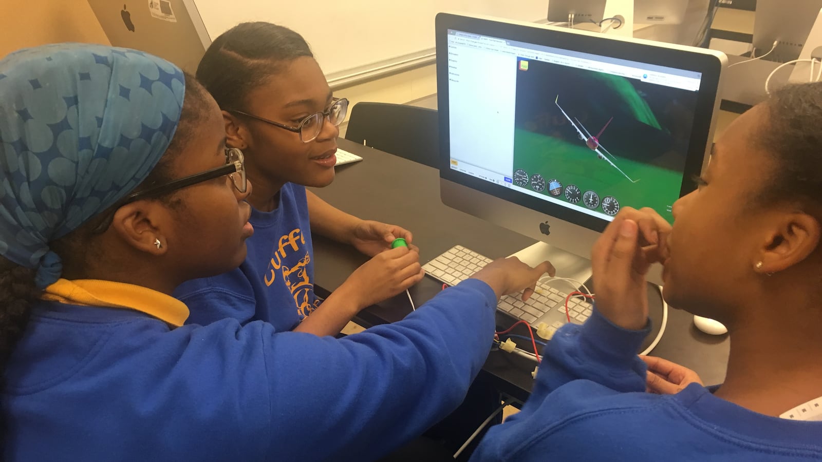 Vanessa Nwaige, center, works on a flight simulator at at Paul Cuffe Math-Science Technology Academy, an elementary school in Chicago on March 19, 2019. The school was one of 32 to receive funding from Chicago Public Schools to add high-demand programs.