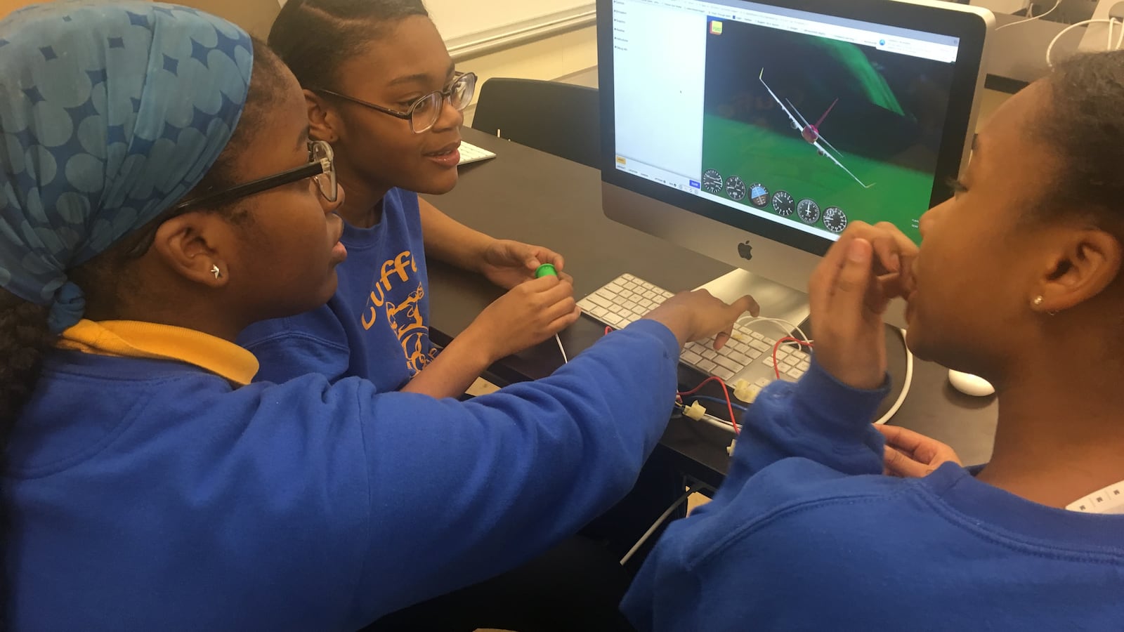 Vanessa Nwaige, center, works on a flight simulator at at Paul Cuffe Math-Science Technology Academy, an elementary school in Chicago on March 19, 2019. The school was one of 32 to receive funding from Chicago Public Schools to add high-demand programs.