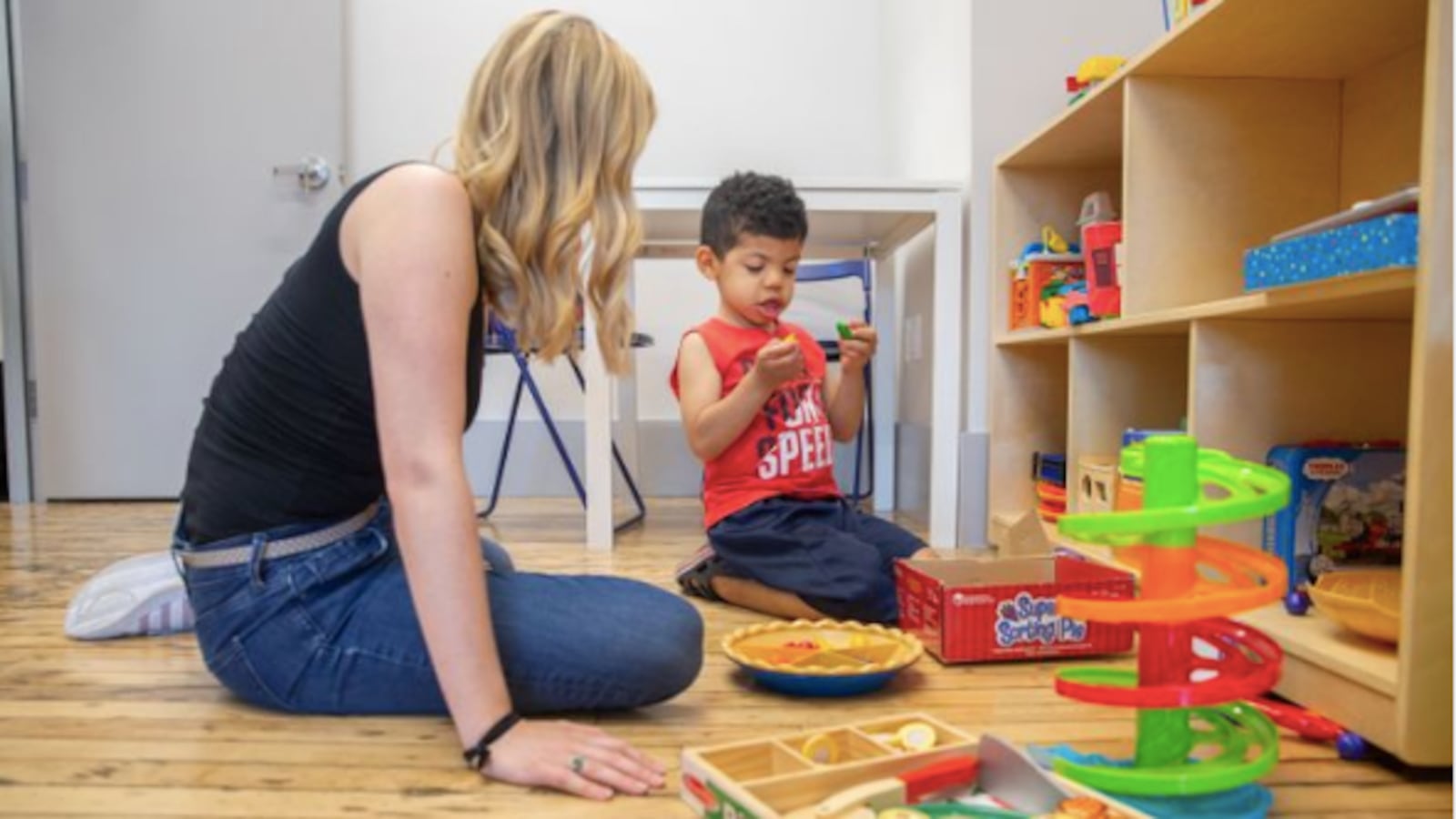 Behavioral therapist Meghan Devine works with 4-year-old Joaquin Rodriguez at the Bridge Kids special education center in Chelsea, June 28, 2019.