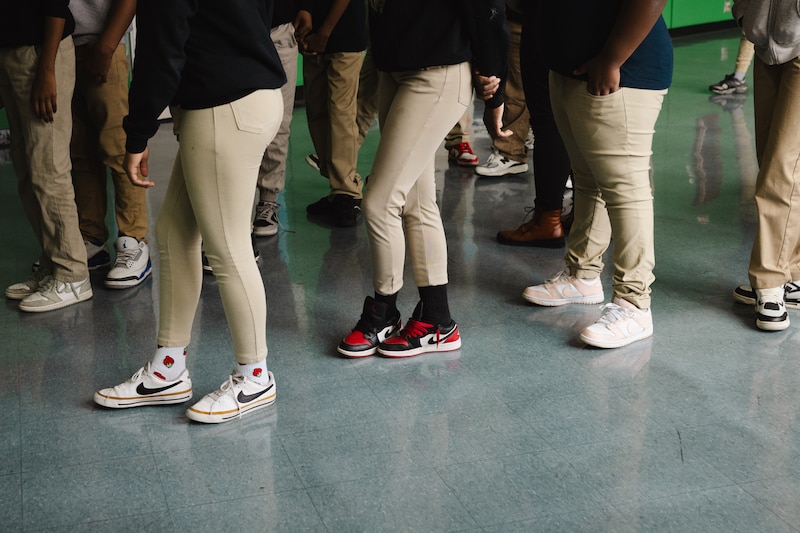 A photograph of students waiting in line to enter a classroom at Johnson.