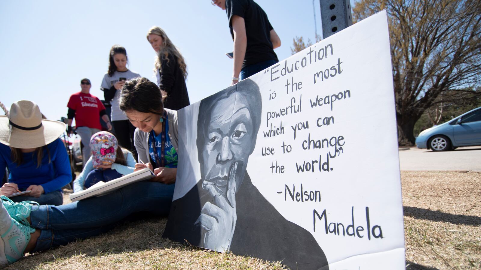 Teacher Laurel Payne, student Aurora Thomas and teacher Elisha Gallegos work on an art project at the state capitol on April 9, 2018 in Oklahoma City, Oklahoma. (Photo by J Pat Carter/Getty Images)