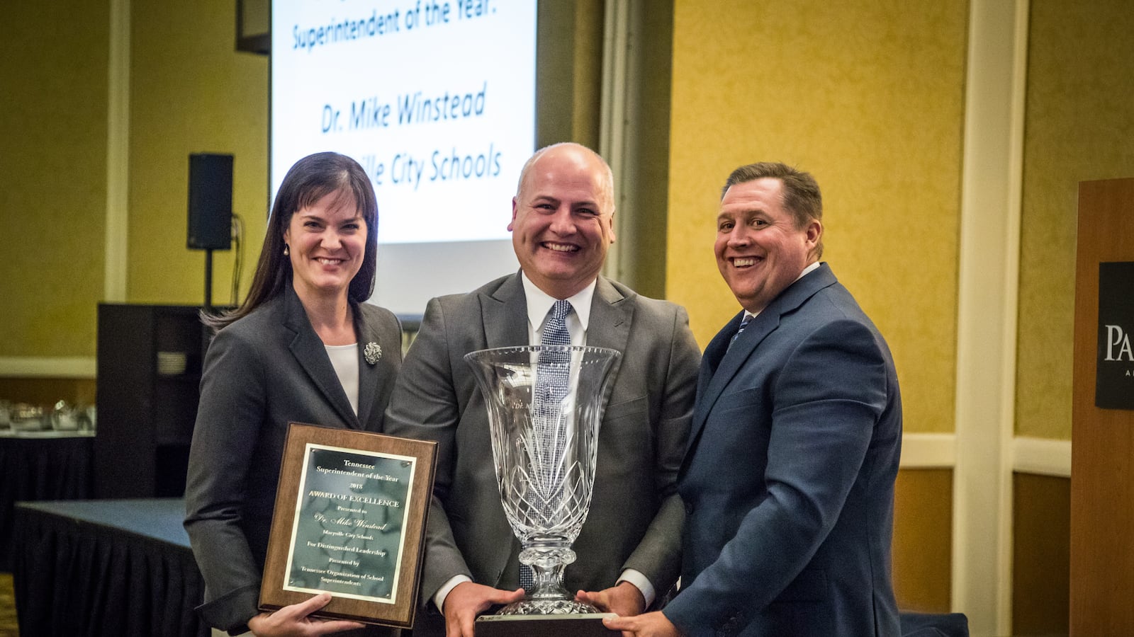 Maryville City Schools Superintendent Mike Winstead (center) receives the 2018 Tennessee Superintendent of the Year award from Education Commissioner Candice McQueen and Dale Lynch, executive director of the Tennessee Organization of School Superintendents.
