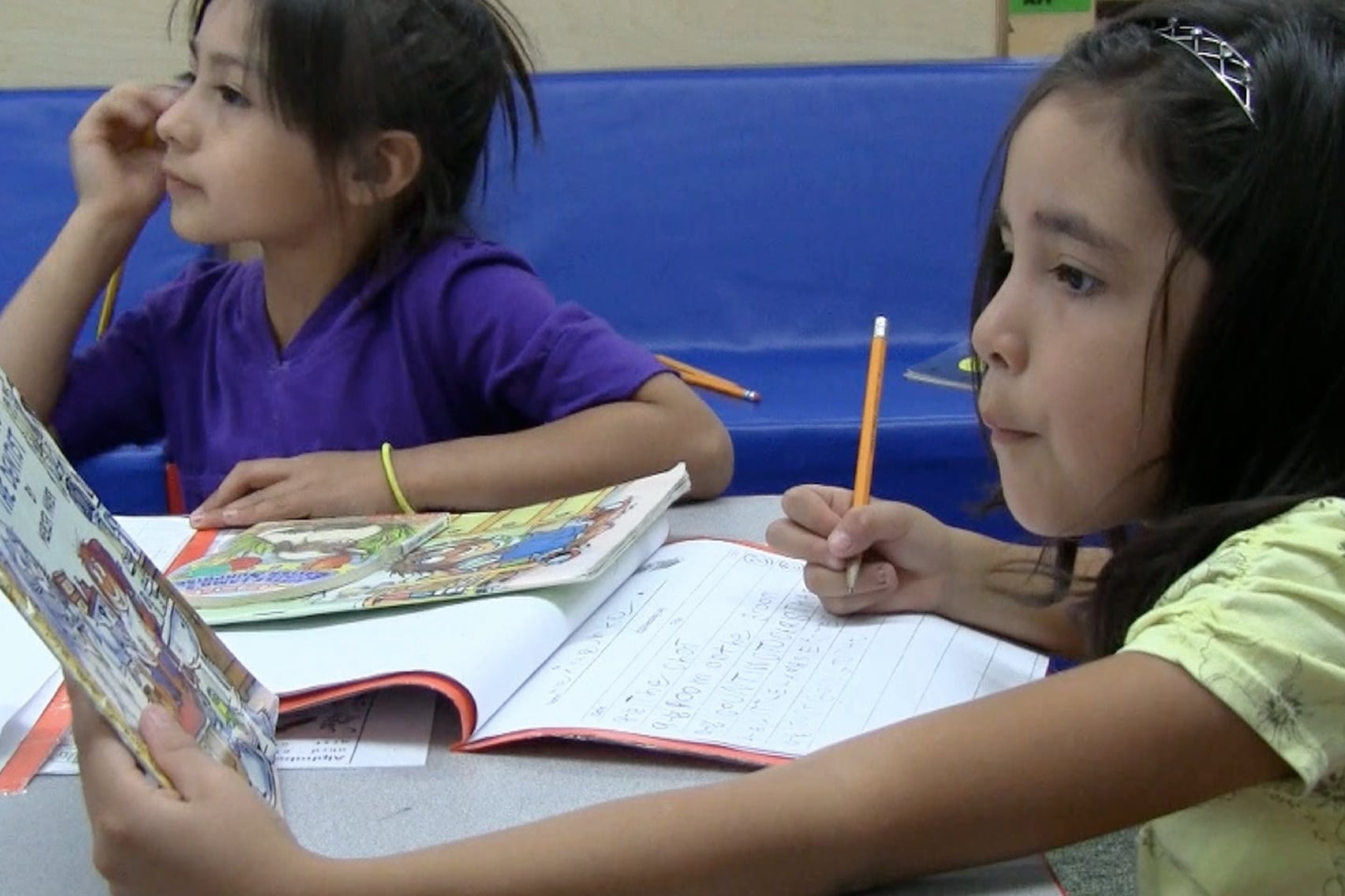 A student fills out her reading log.