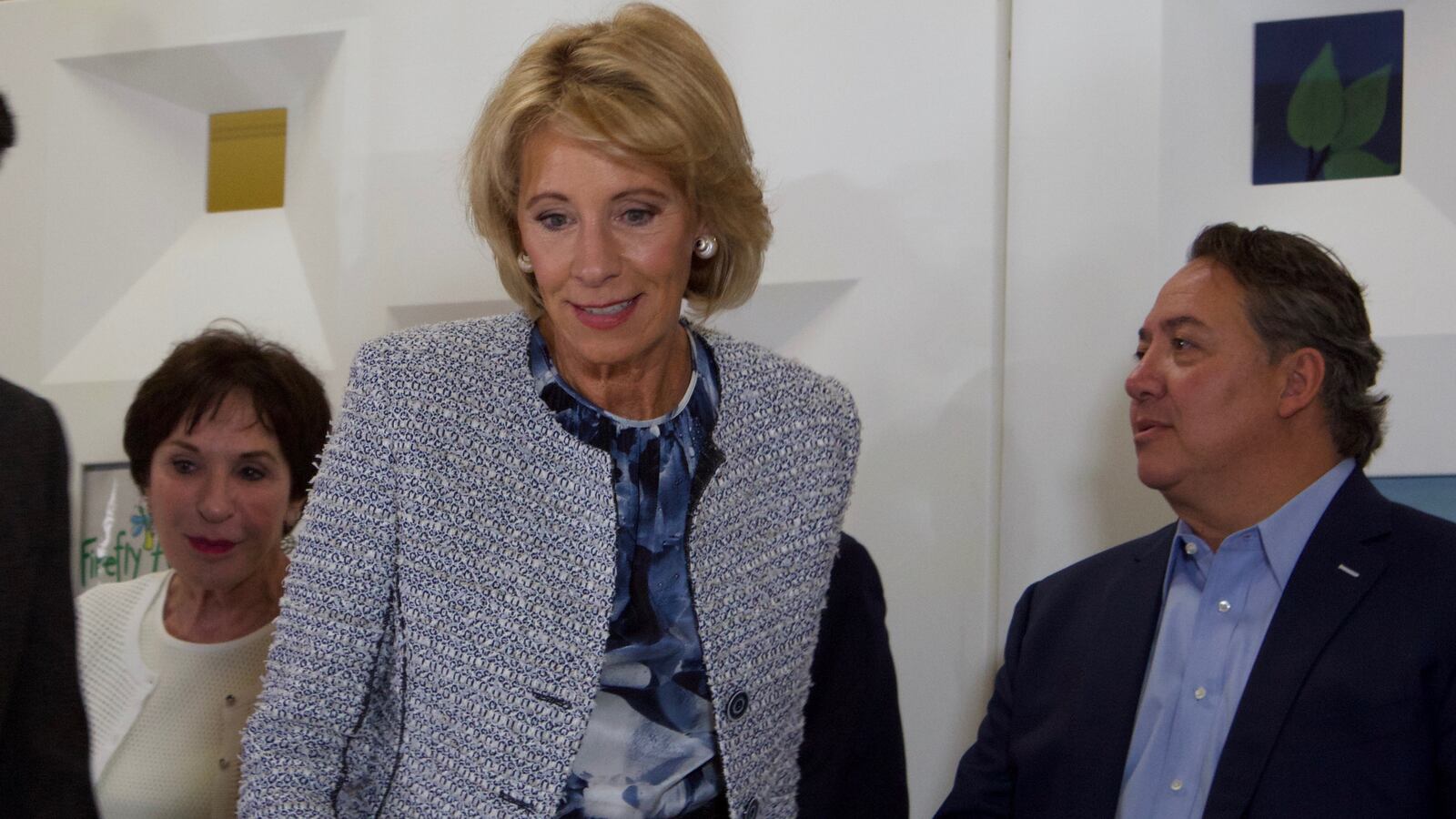 U.S. Education Secretary Betsy DeVos takes her seat at the Firefly Autism center in Denver.