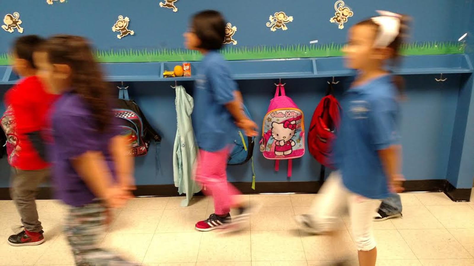 In place of tall olive green lockers at Trevista at Horace Mann: hooks and shelves that 4-year-olds can reach.