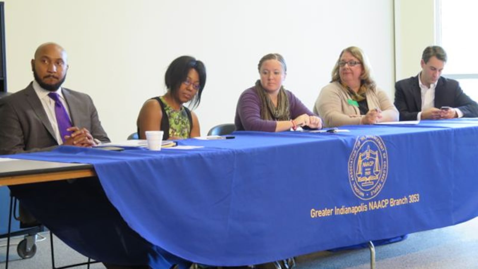 Five of the 10 candidates seeking election to the Indianapolis Public School Board sit at a candidate forum hosted by the Greater Indianapolis NAACP chapter.