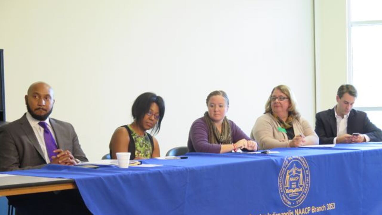 Five of the 10 candidates seeking election to the Indianapolis Public School Board sit at a candidate forum hosted by the Greater Indianapolis NAACP chapter.