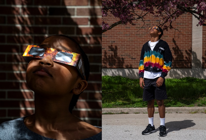 Two photos of two young students wearing solar eclipse viewing glasses while posing for a portrait.