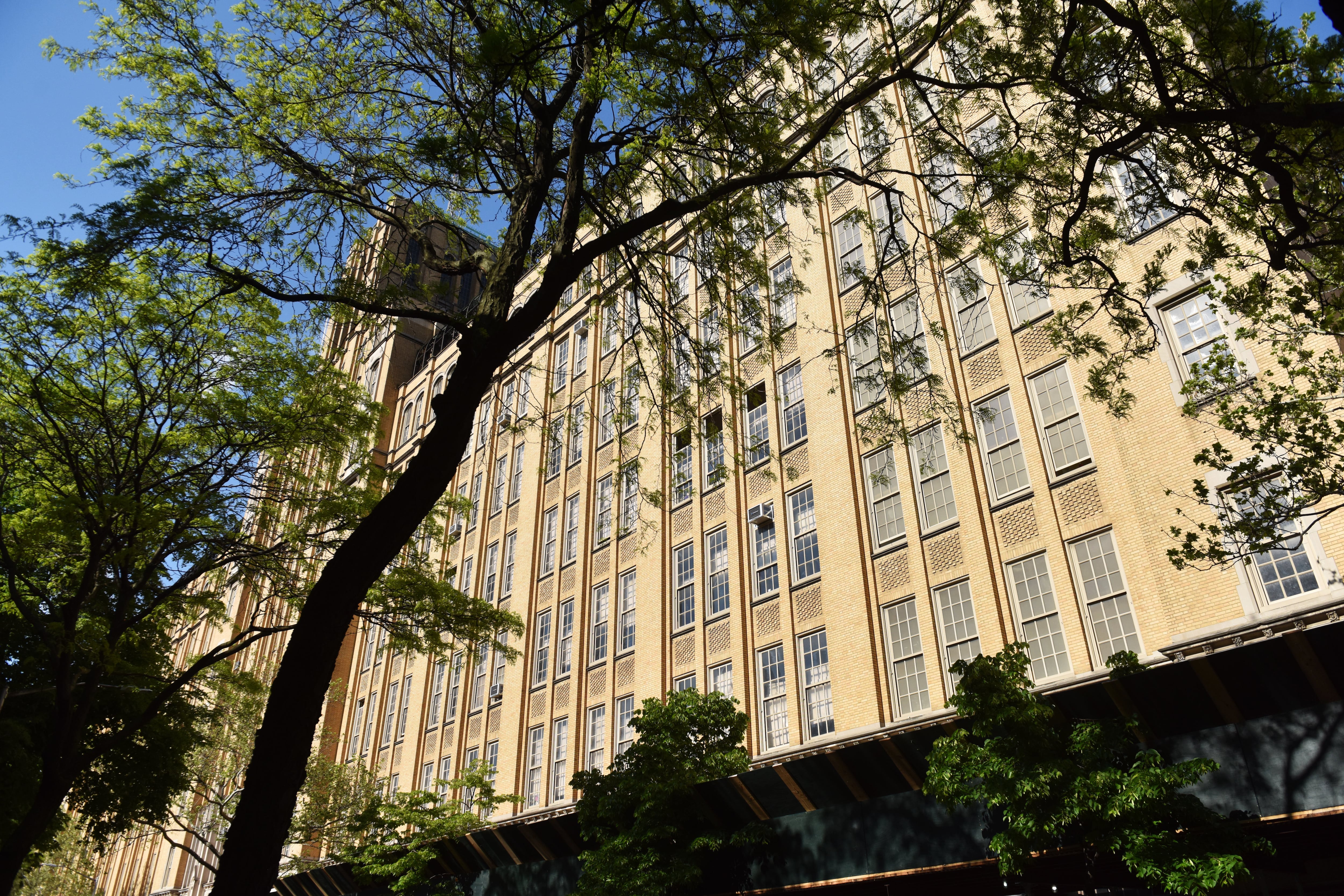 A large beige building with a lot of windows