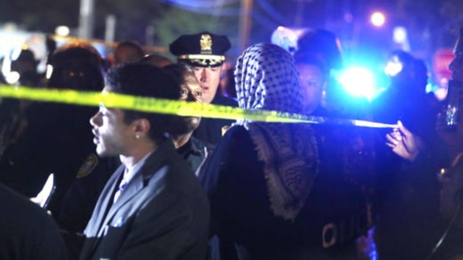Memphis police officers talk with people following a fatal shooting involving U.S. Marshals in Frayser on Wednesday.