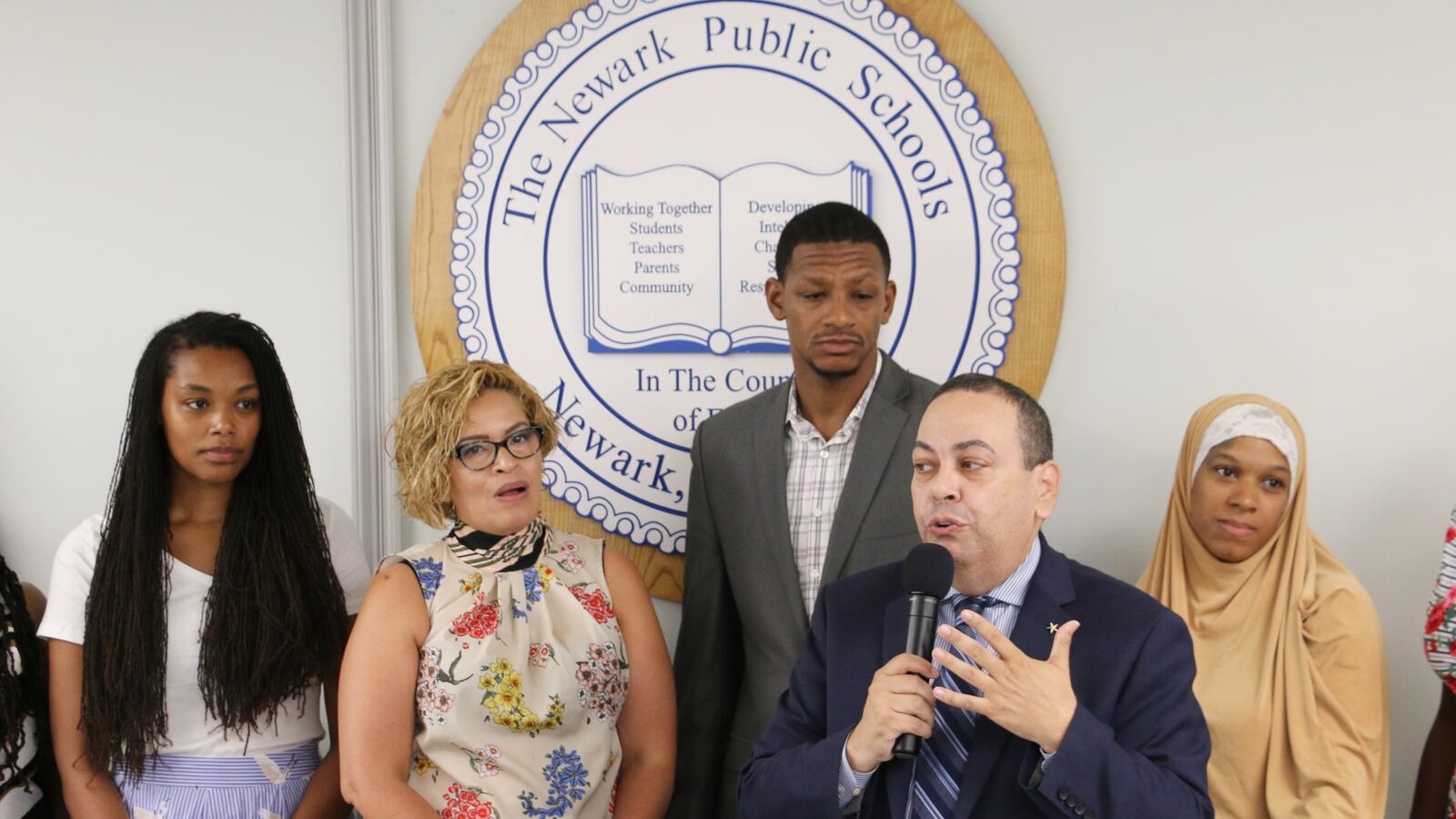 Shabazz High School's new principal, Naseed Gifted (third from left), with school board members and Superintendent Roger León.