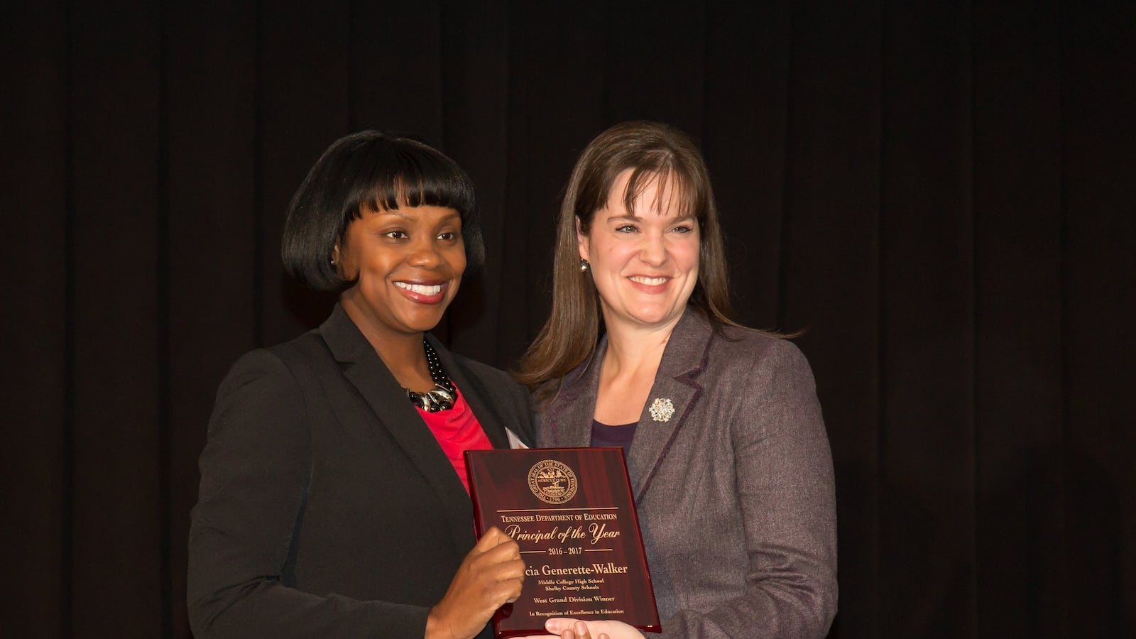 From left: Docia Generette-Walker receives Tennessee's 2016 principal of the year honor from Education Commissioner Candice McQueen. Generette-Walker leads Middle College High School in Memphis.
