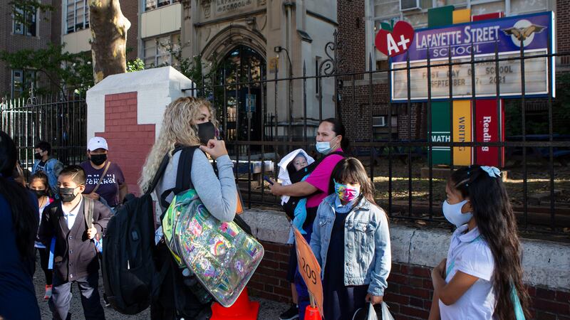 Several students and parents make their way into Newark’s Lafayette Street School on the first day of classes.