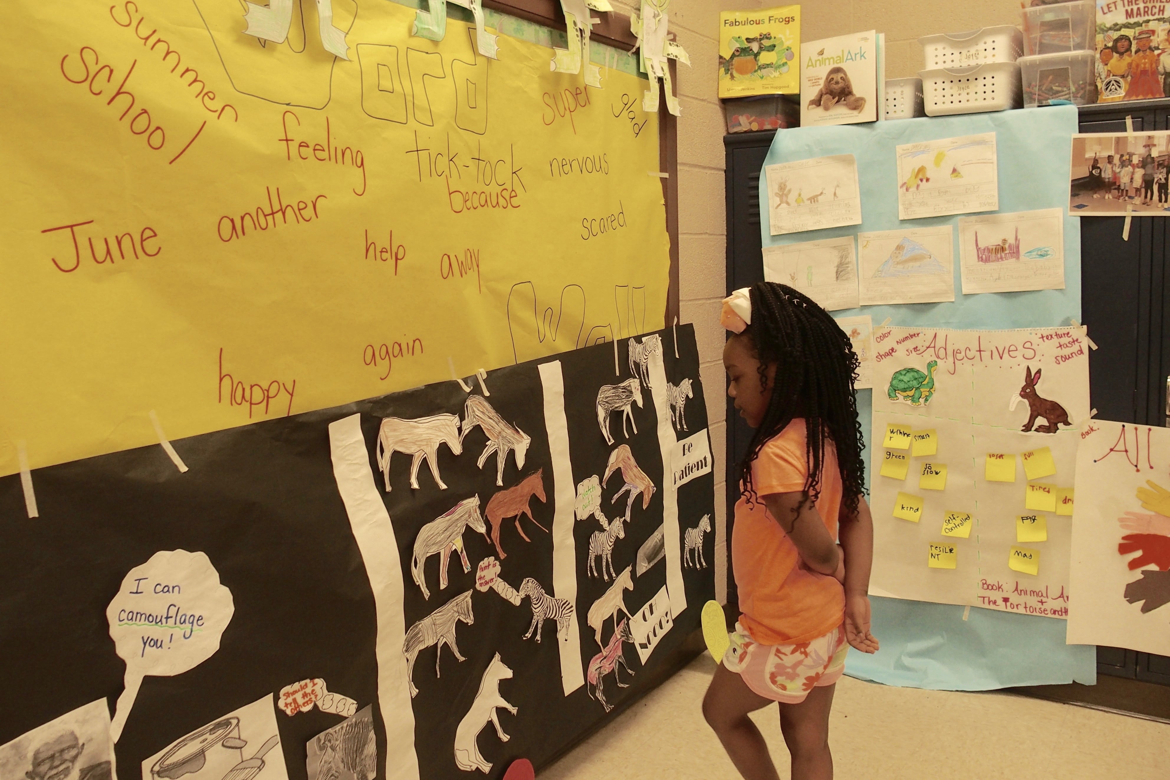 Ari Bouie, 6, shows off the art project she made after reading different fables during the monthlong Read to be Ready literacy camp held at Cornerstone Prep in Memphis' Frayser neighborhood.