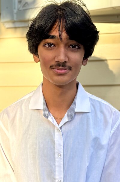 A photo of a teenage boy in a white collared shirt.