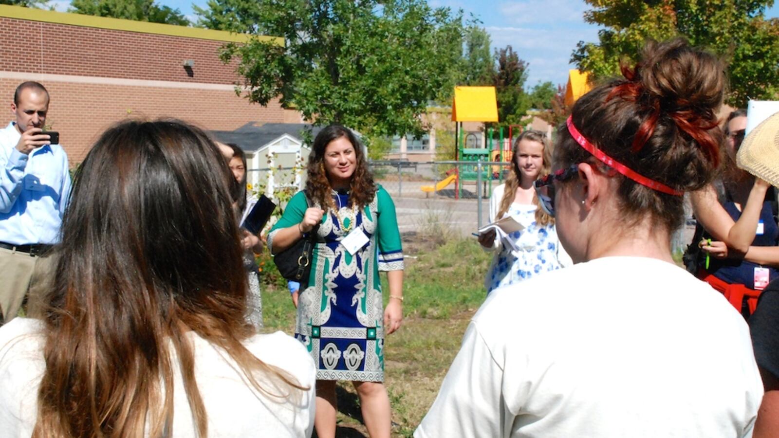Andrea Suarez Falken, center, listens to students from the Denver Green School share some sustainability lessons Tuesday. Suarez Falken is the director of the U.S. Department of Education Green Ribbon Schools. Her team is on a statewide tour of schools that are both high performing and eco-friendly this week.