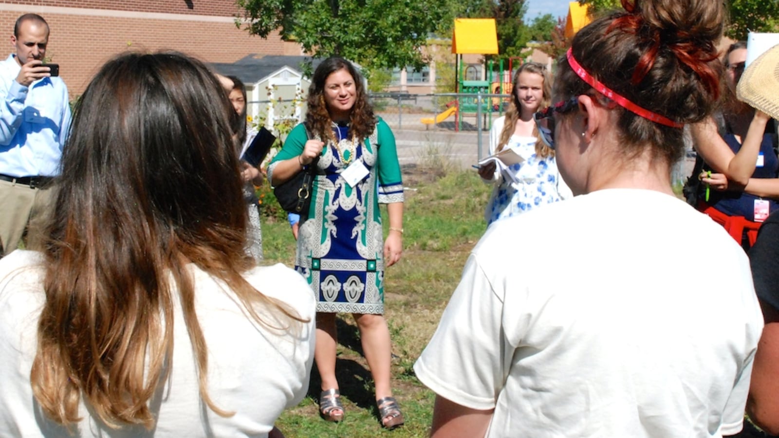 Andrea Suarez Falken, center, listens to students from the Denver Green School share some sustainability lessons Tuesday. Suarez Falken is the director of the U.S. Department of Education Green Ribbon Schools. Her team is on a statewide tour of schools that are both high performing and eco-friendly this week.