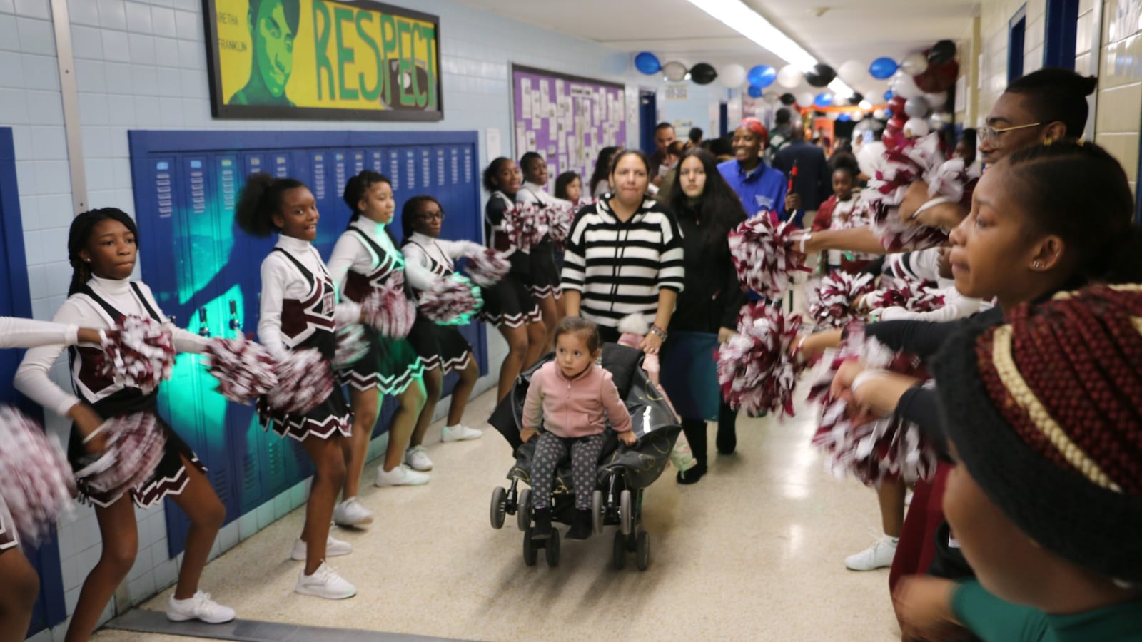 Cheerleaders from University High School greeted families at Newark's school enrollment fair on Saturday.