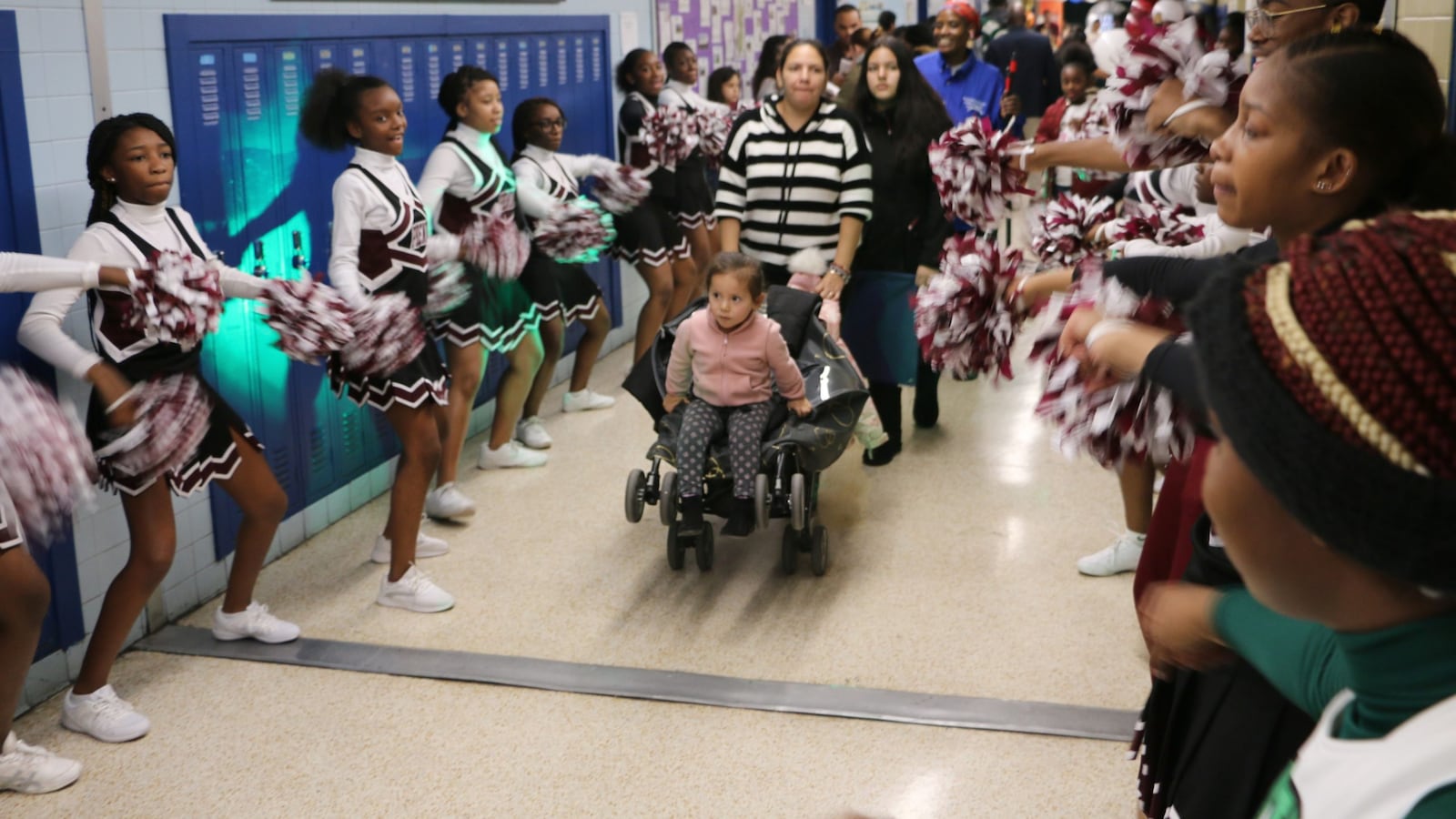 Cheerleaders from University High School greeted families at Newark's school enrollment fair on Saturday.