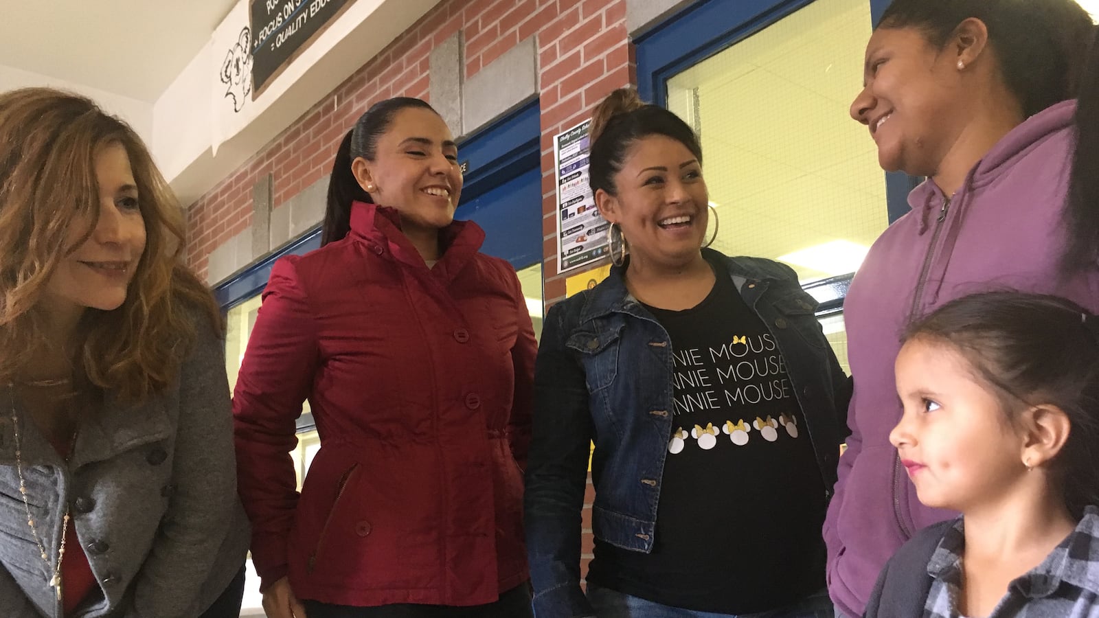 Kate Bond Elementary School's bilingual mentor Lissette Bailey, left, talks with parents after a recent English class.