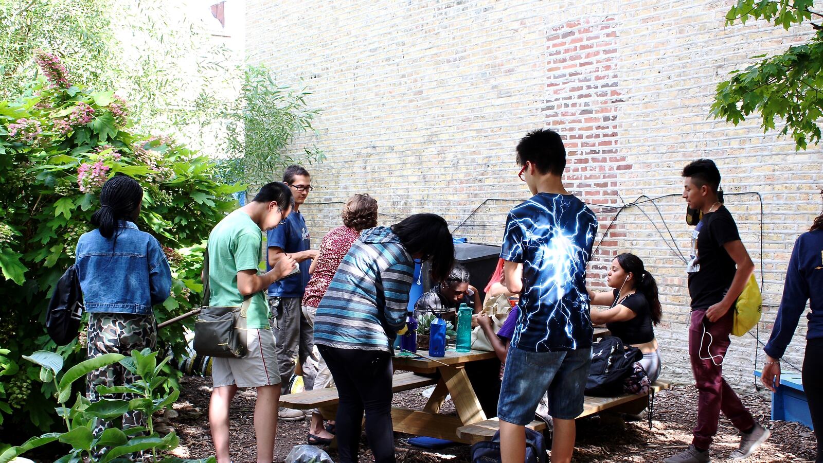 Teens gather in Jardin De Las Mariposas Garden for an After School Matters program