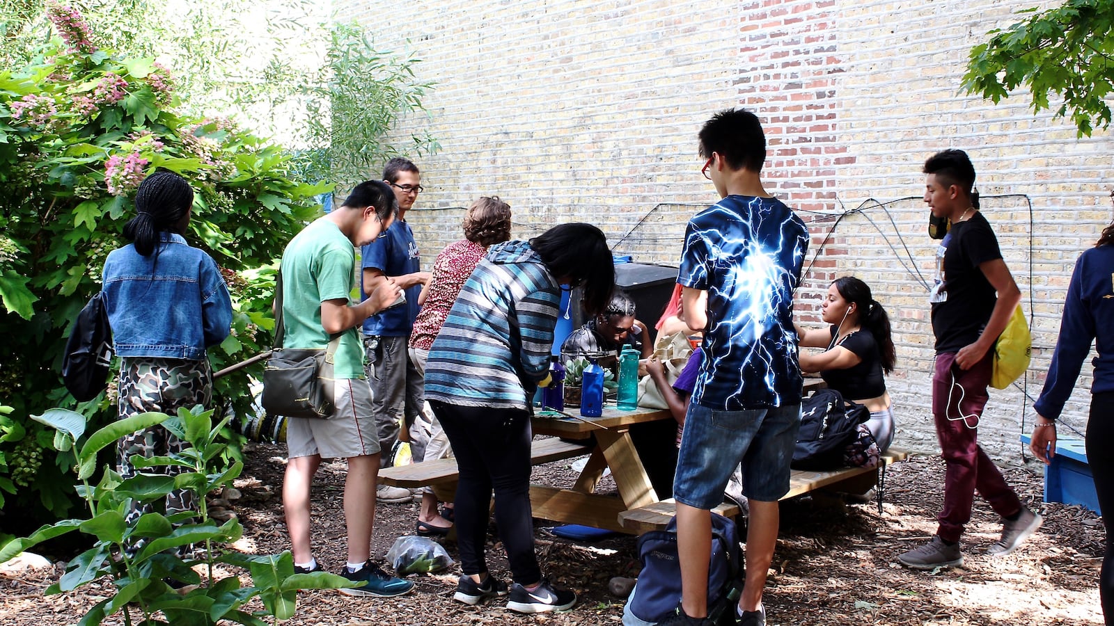 Teens gather in Jardin De Las Mariposas Garden for an After School Matters program