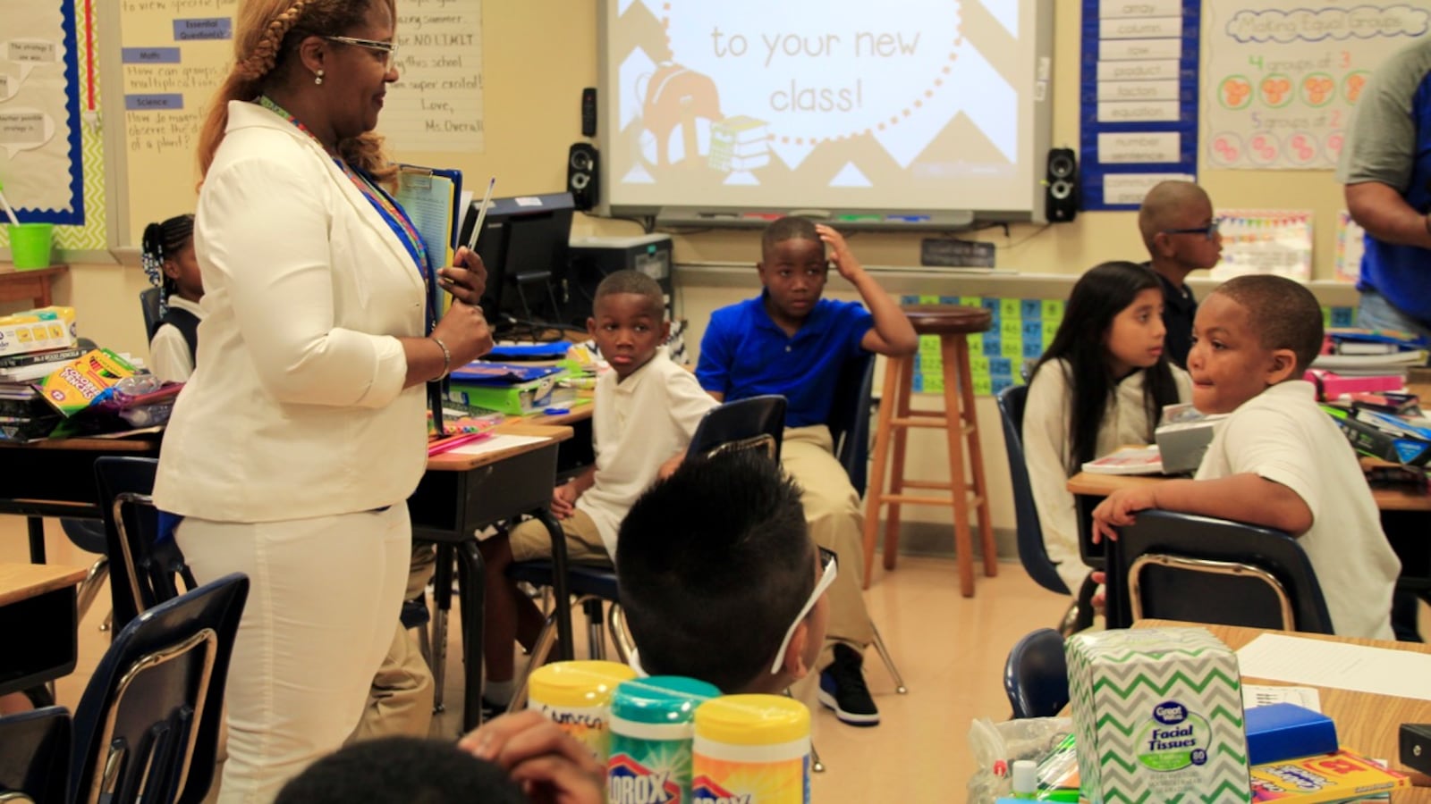 A third-grade teacher at Bruce Elementary welcomes her class on the first day of school.