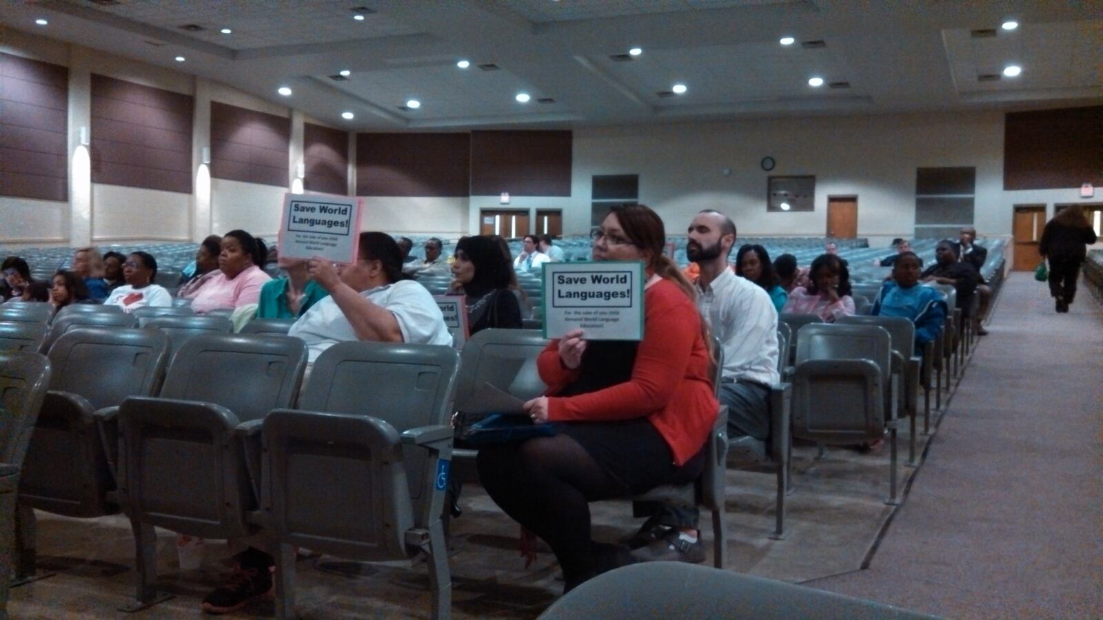 Shelby County Schools' elementary and middle school world language teachers hold signs in protest of the budget cuts affecting the program.