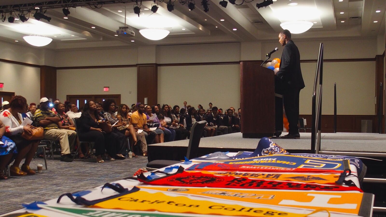 A graduating senior speaks during an Academic Signing Day ceremony for Freedom Preparatory Academy, a Memphis charter school whose entire first graduating class is headed to college. Banners were on display to represent the schools they'll attend.