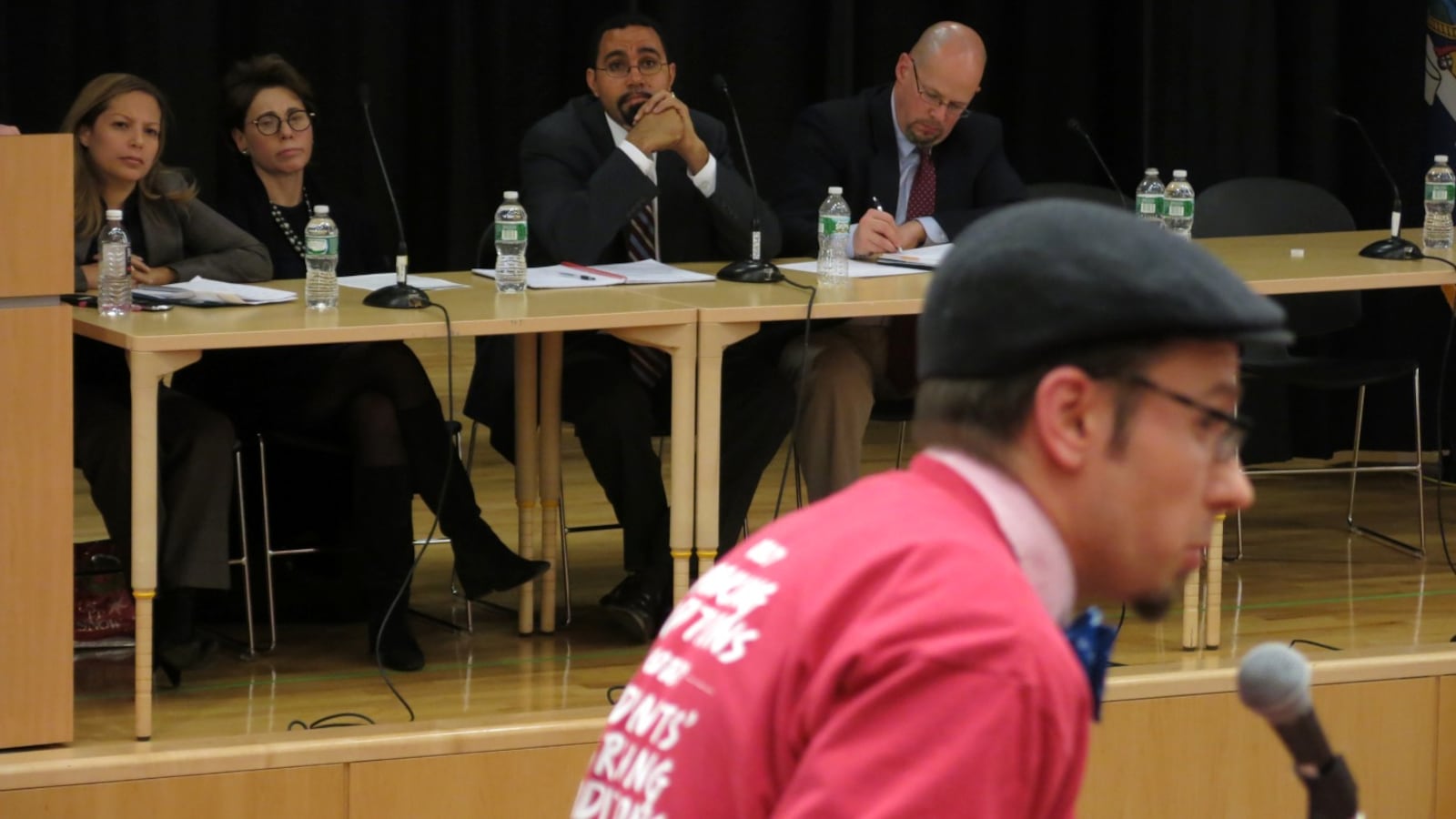State Education Commissioner John King (center) listens to a critic during one of a series of heated Common Core forums last fall. Backlash against the new standards went mainstream this year.