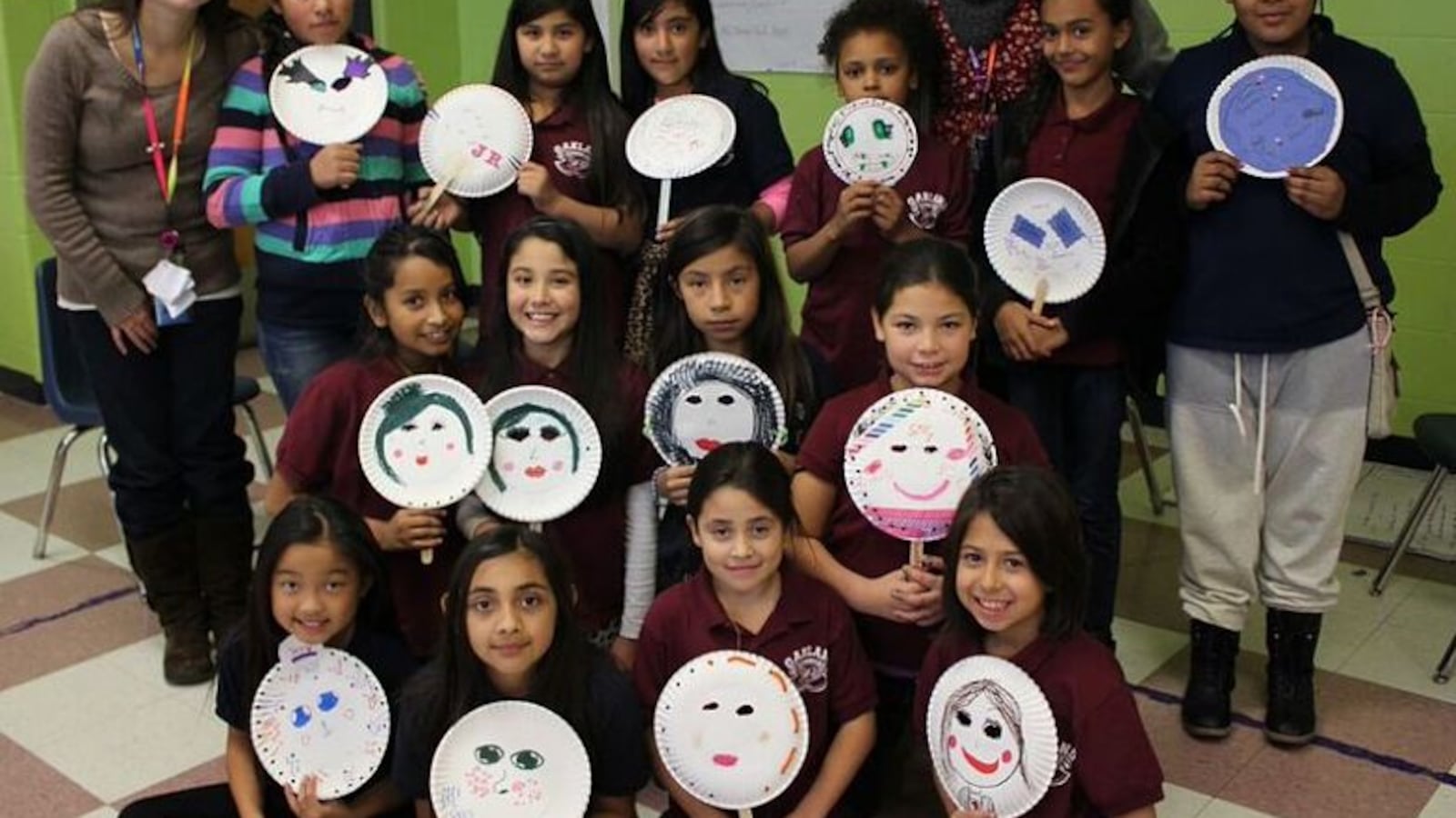 Students at Oakland Elementary hold up masks they decorated to represent who they are on the inside. The activity was part of one of the school's preventative programs for girls. (Photo courtesy of Oakland)