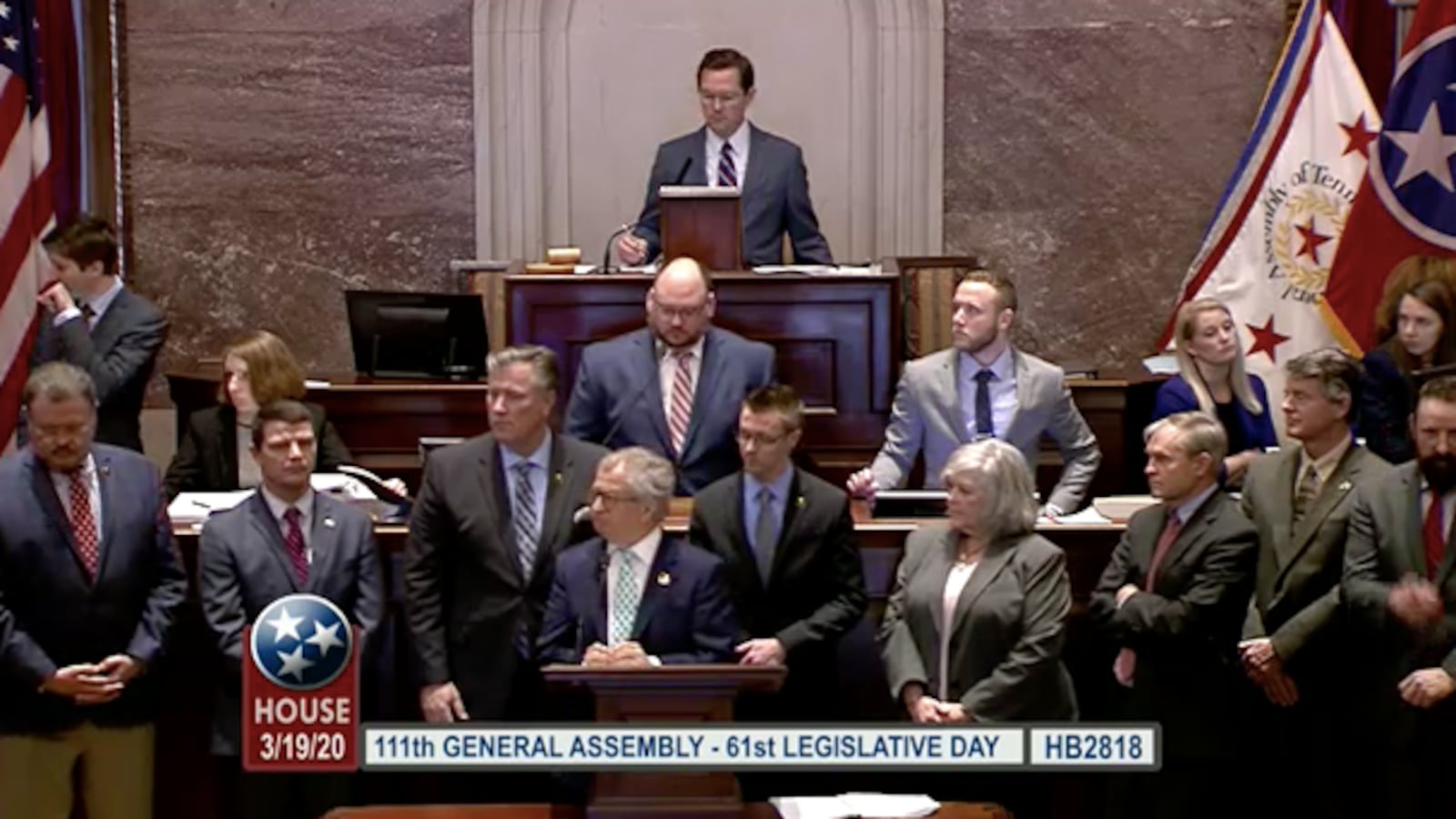 Surrounded by members of his committee, Education Chairman Mark White (front center) presents the emergency school proposal to the House of Representatives on Thursday.