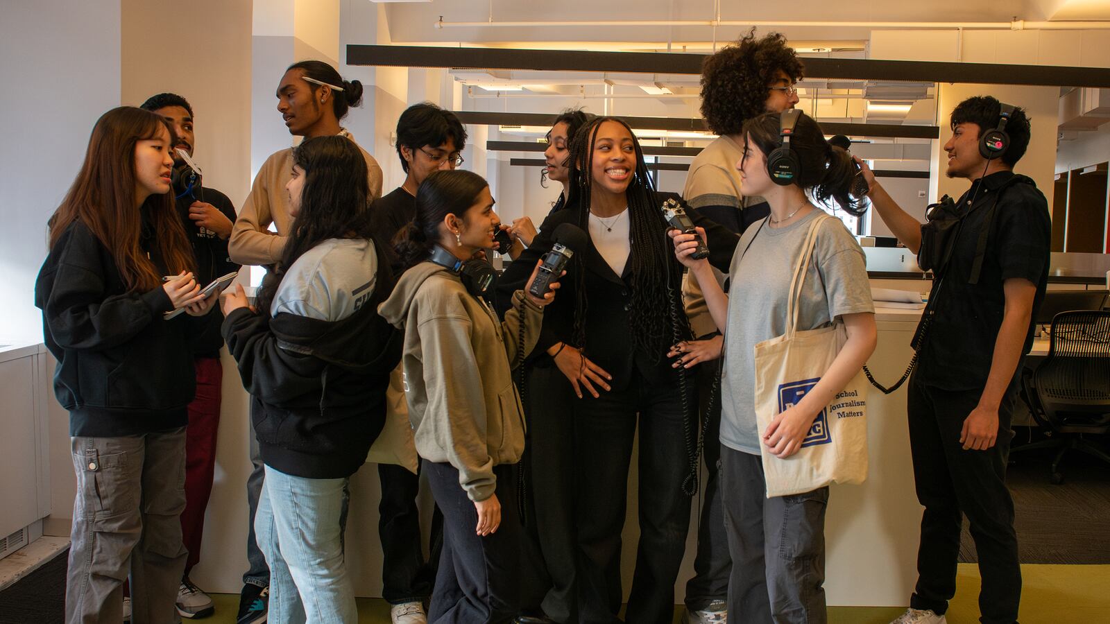A group of high school teenagers pose for a portrait.