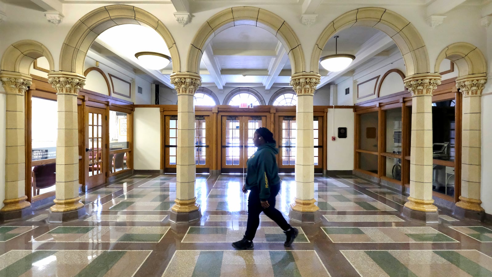 Student walks down a hallway at Crispus Attucks High School.