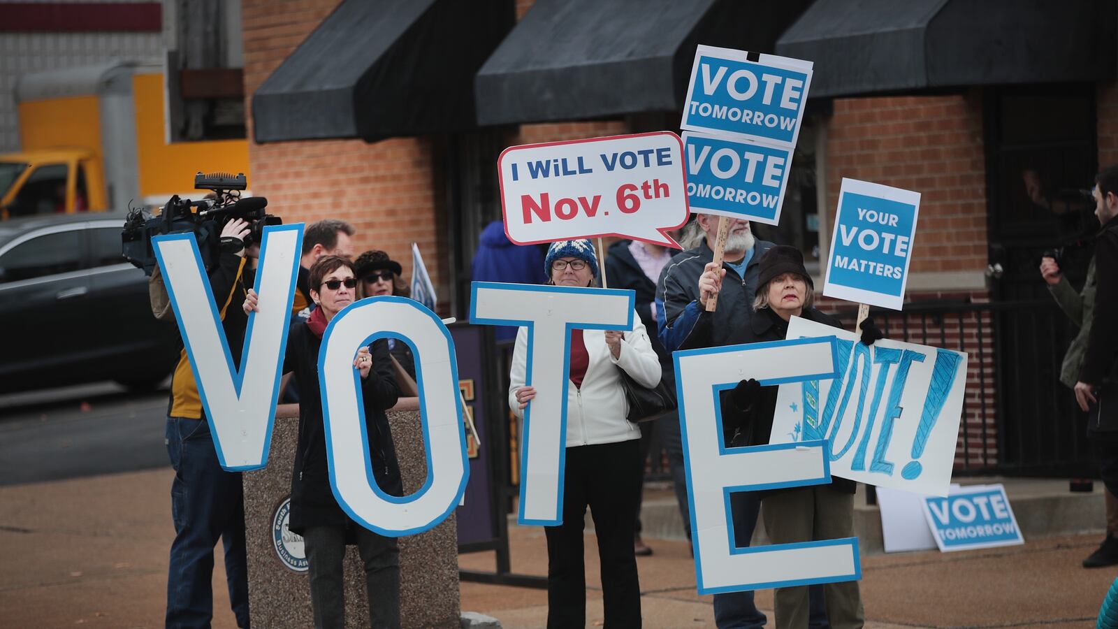 Supporters of Senator Claire McCaskill (D-MO) with signs that say vote wait for the senator to arrive for a campaign stop at The Royale bar on November 5, 2018 in St. Louis, Missouri. (Photo by Scott Olson/Getty Images)