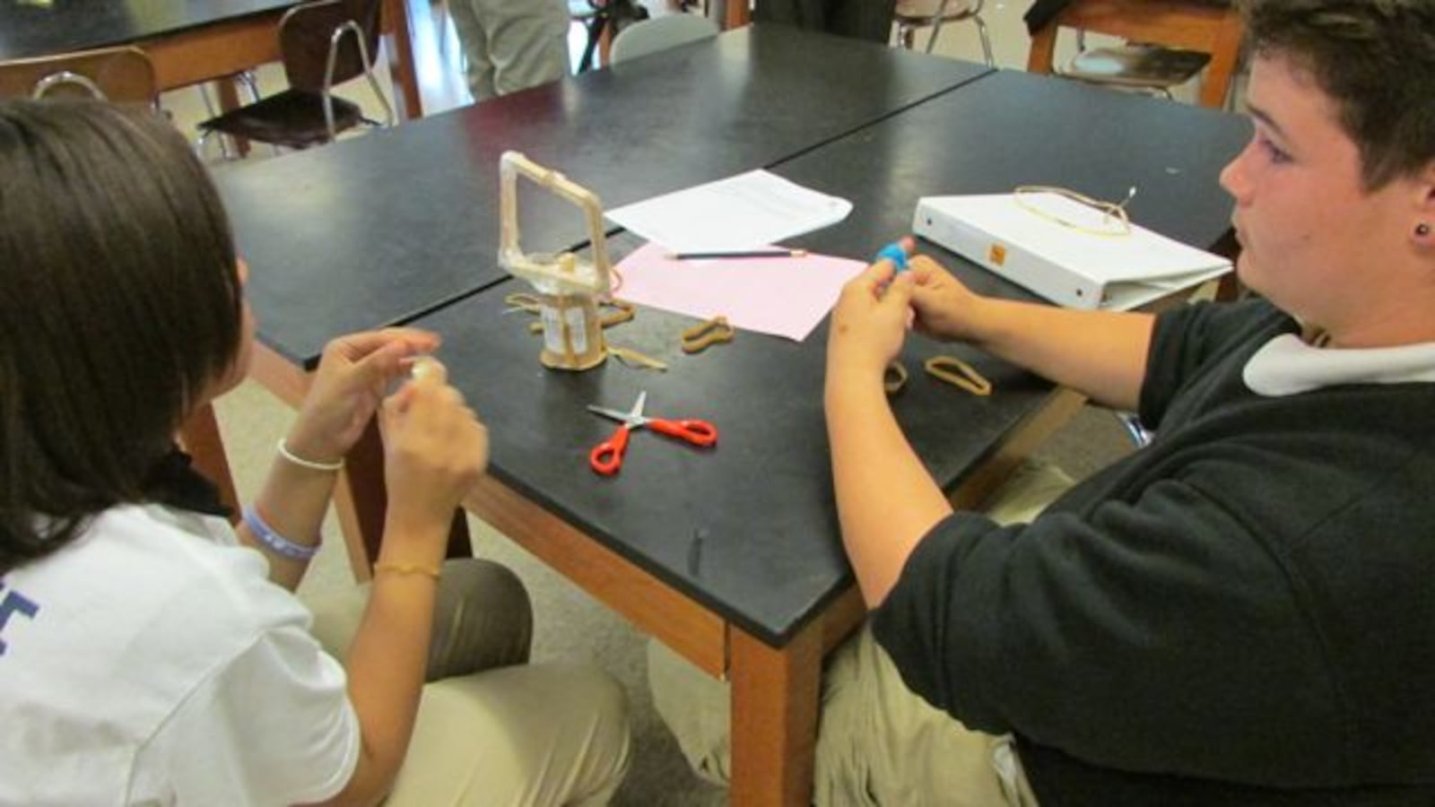 Students at Harshman Middle School, where Jack Hesser is a teacher, work on science projects.