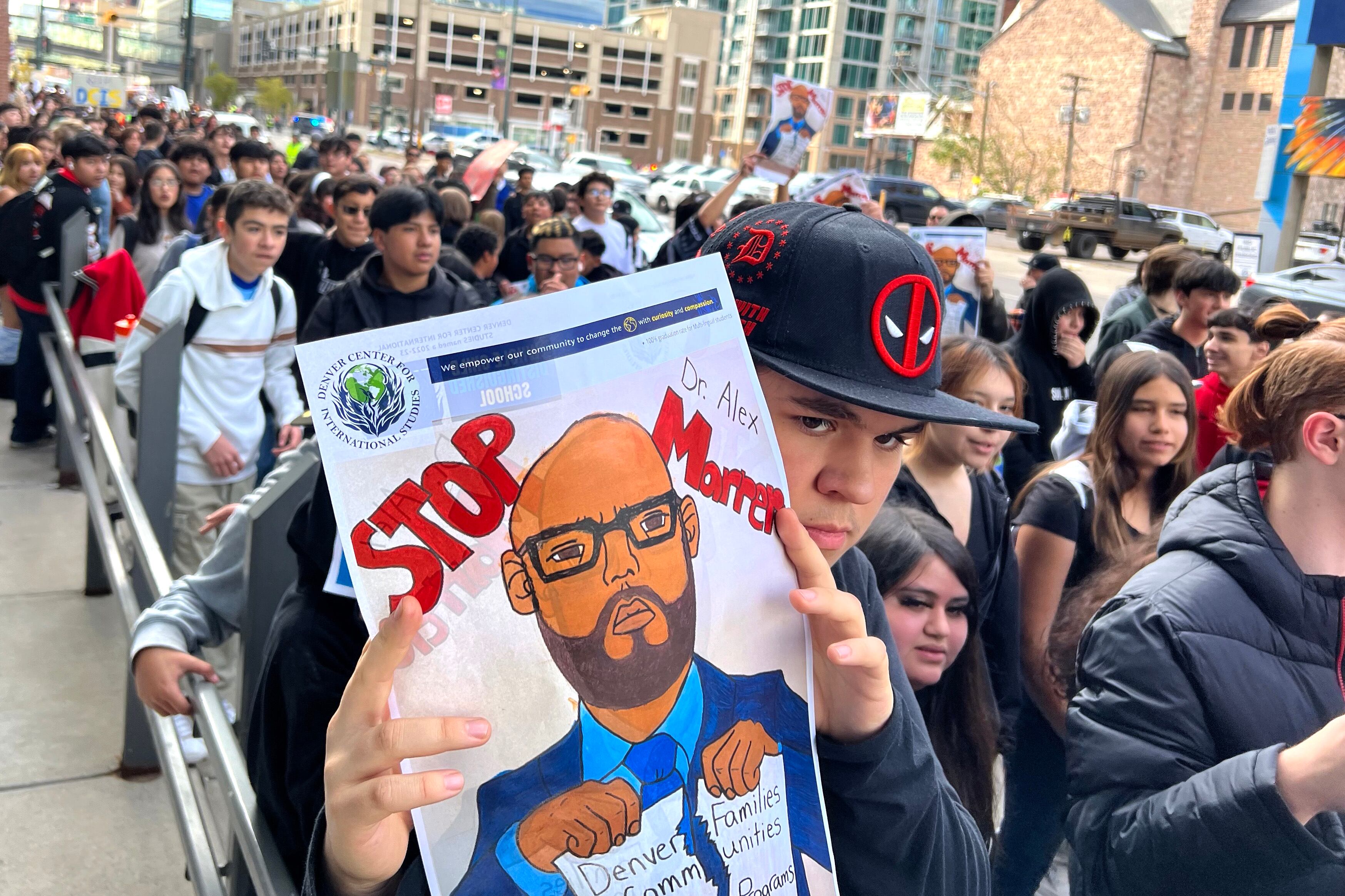 Lots of students protest and hold signs.