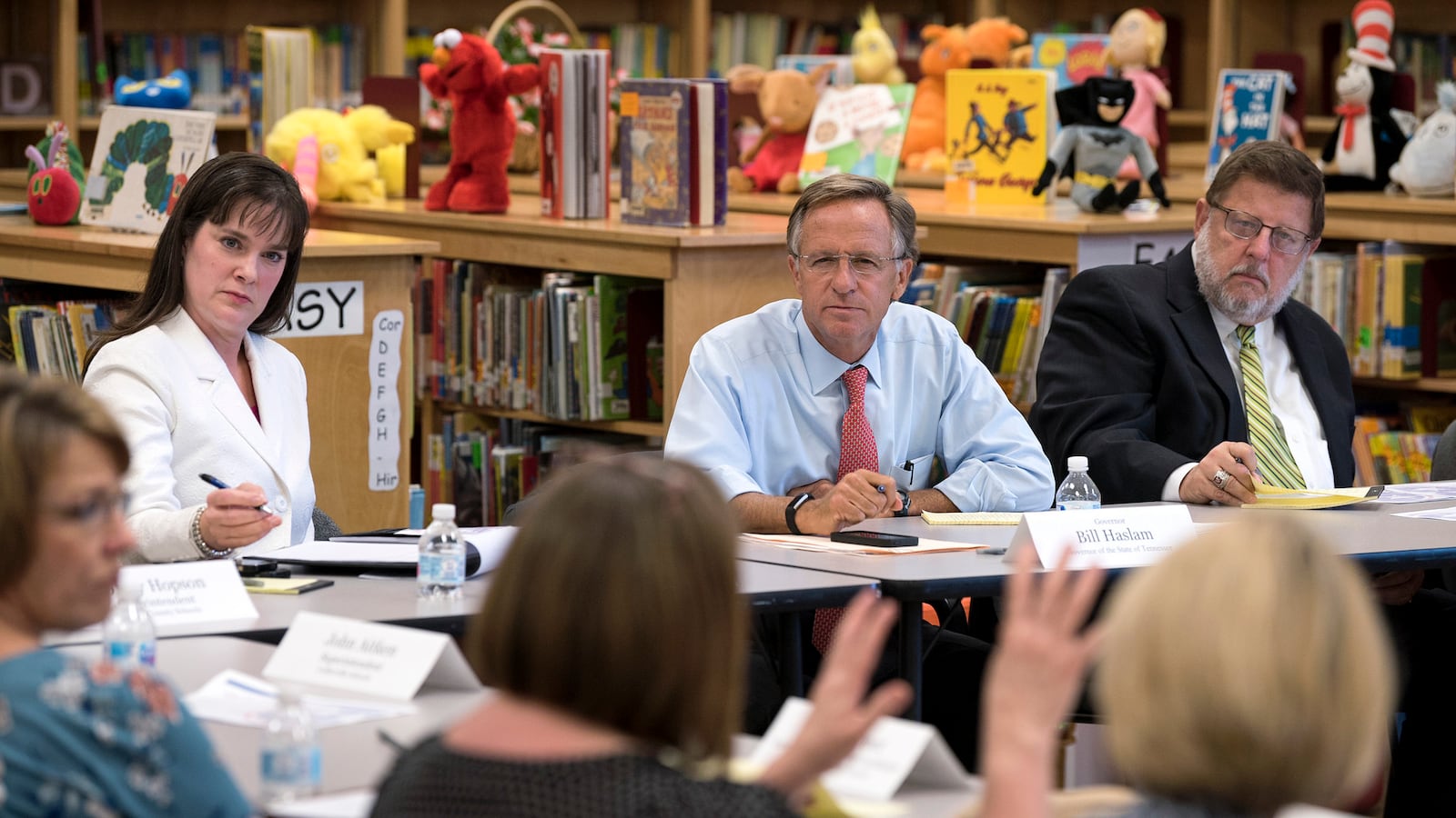 Gov. Bill Haslam (center) listens to feedback of teachers, school administrators, and testing coordinators during an Aug. 30 roundtable session in Shelby County. His education commissioner, Candice McQueen (left) participated in all six roundtable gatherings, along with Wayne Miller (right), the retired chief of the state's superintentents association, who chaired Haslam's "listening tour" advisory team.