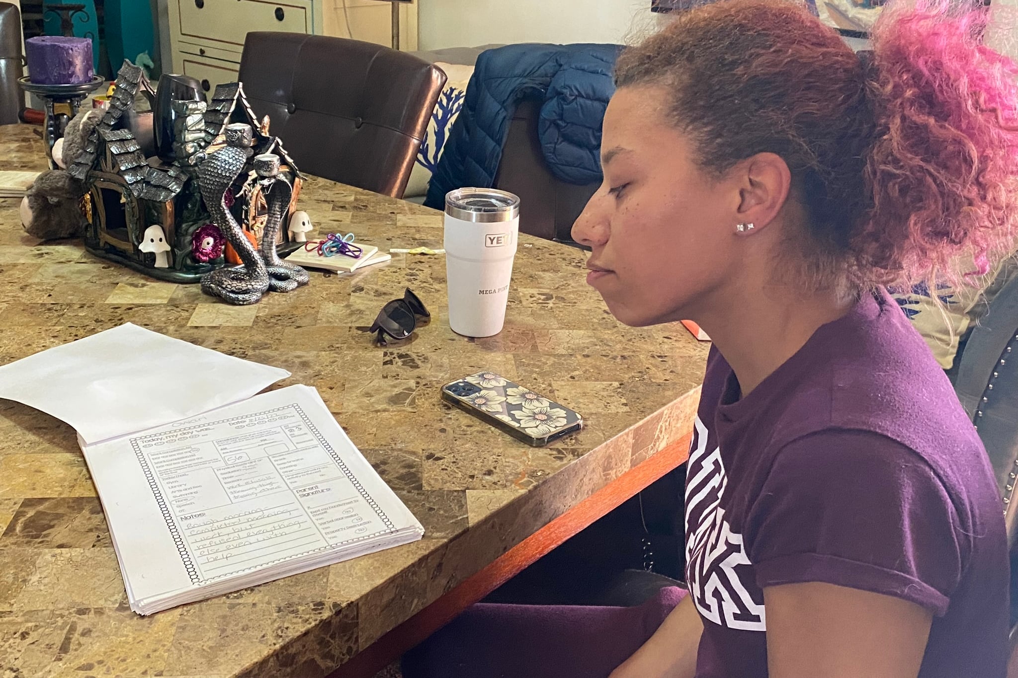 A woman looks at papers on a table
