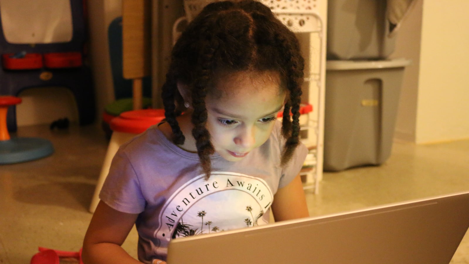 Jazmiah Vasquez, who has been out of school since 2017, plays a computer game at home.