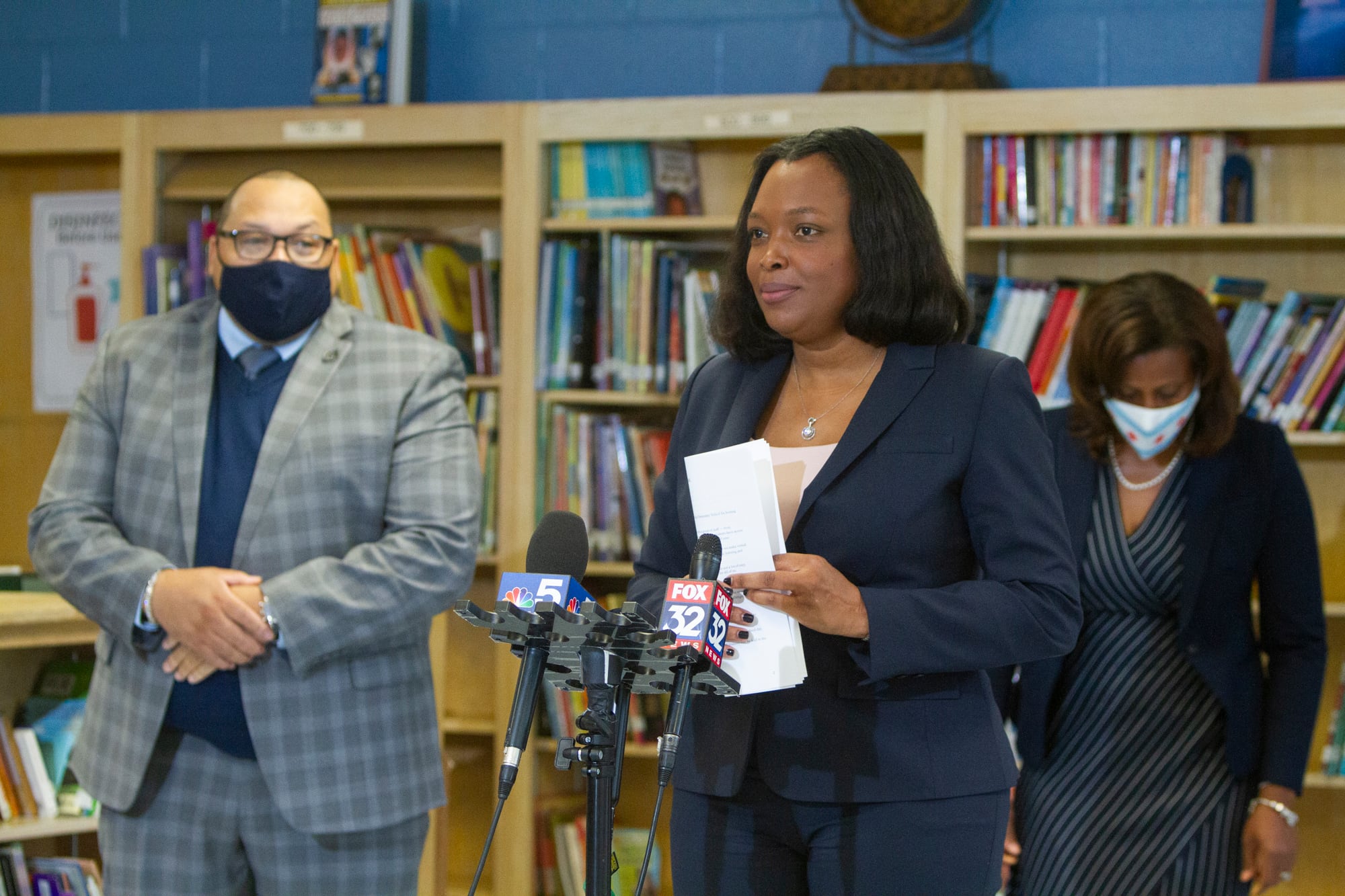 School chief Janice Jackson standing by a microphone.