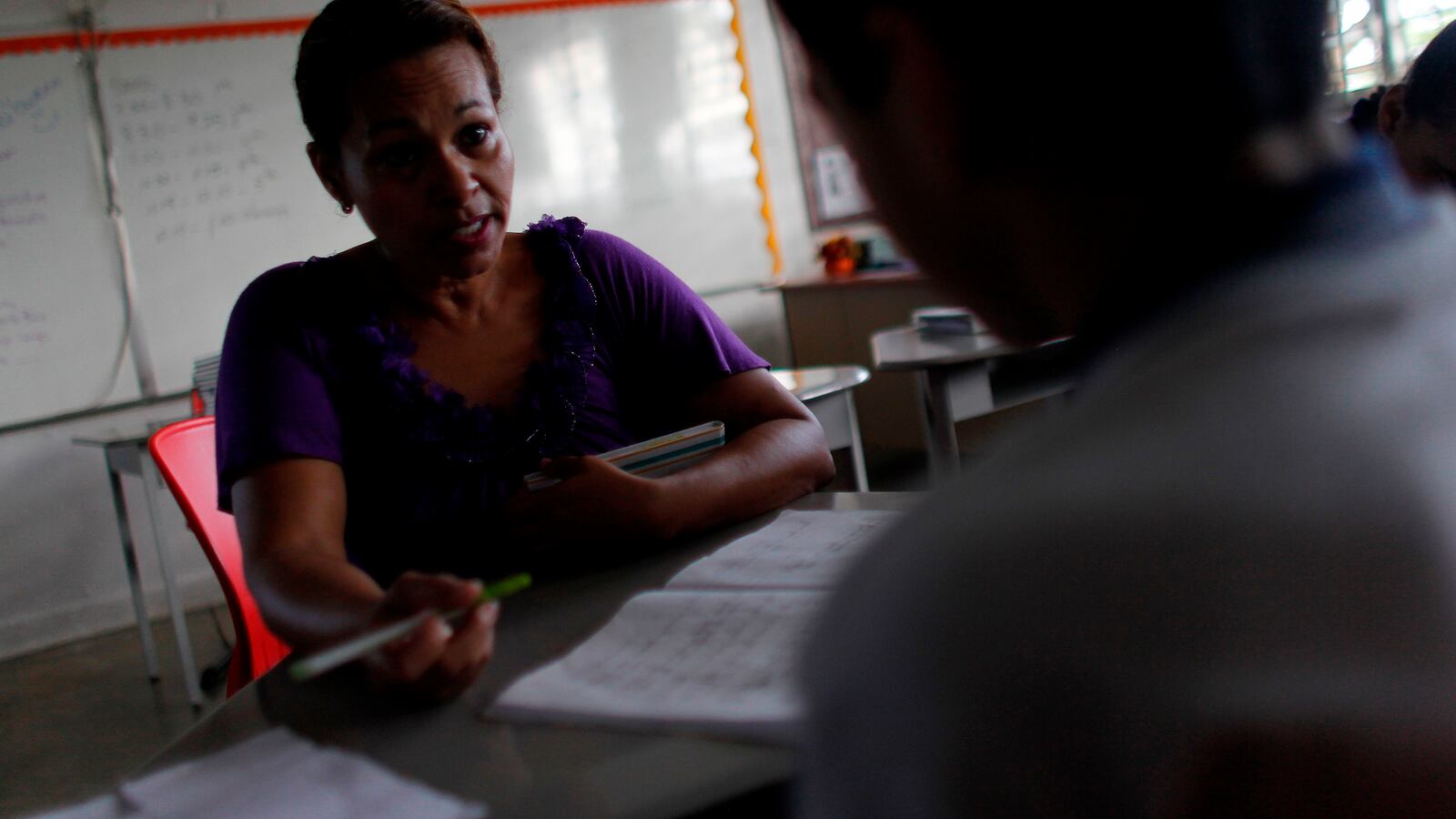 English class teacher Joan Rodriguez talks to one of her 6th grade student at the Sotero Figueroa Elementary School in San Juan, Puerto Rico, November 6, 2017.The school reopened its doors without electricity to receive students 46 days after Hurricane Maria hit the island. (RICARDO ARDUENGO/AFP/Getty Images)