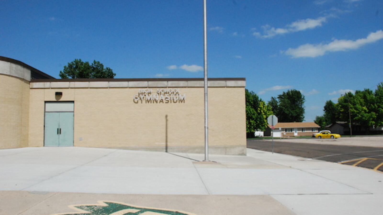 Holyoke's high school gym with the emblem -- a flame -- of the school's dragon mascot in front.