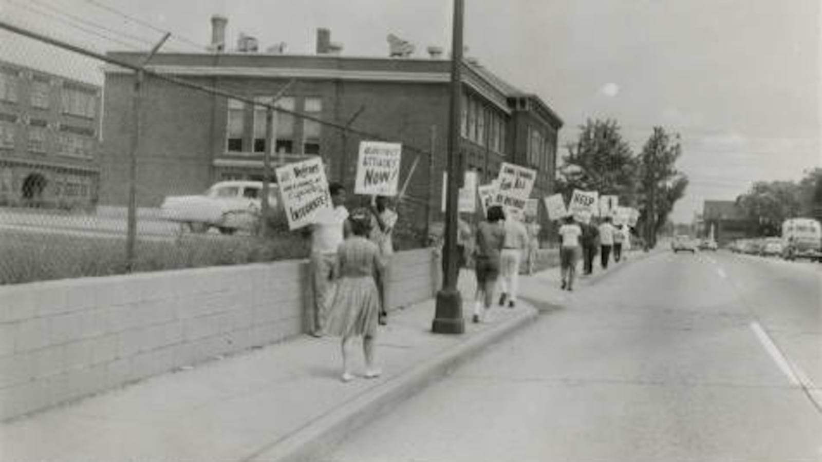 Protestors carried signs asking for school redistricting and integration. They were on the sidewalk in front of IPS School 17 in the 1960s.