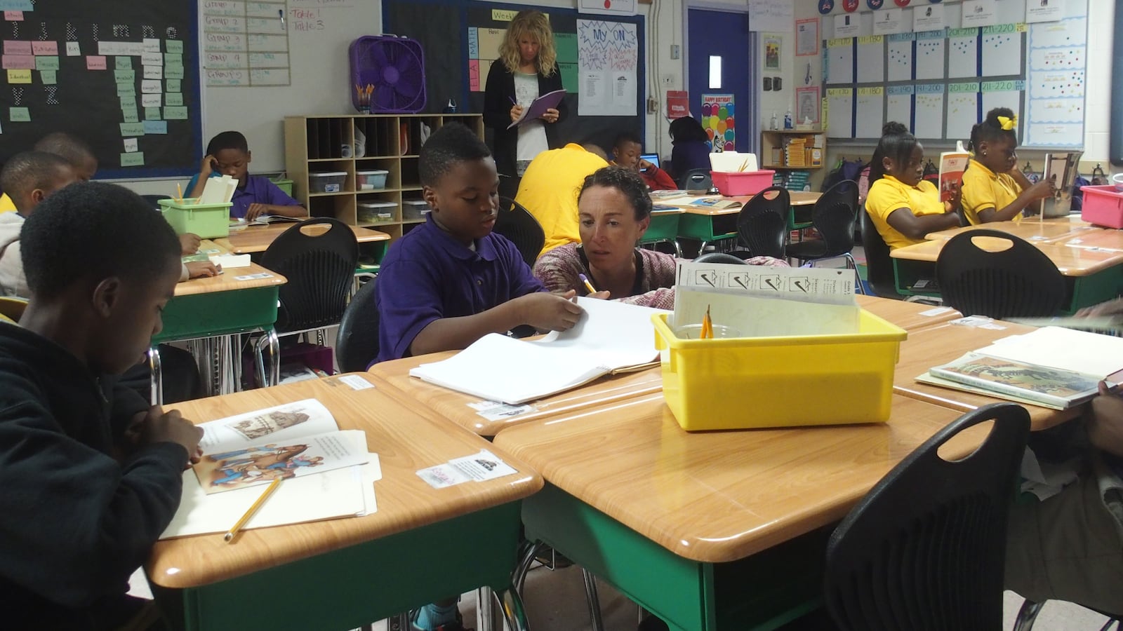 Aspire CEO Carolyn Hack talks with a student at Hanley 1 Elementary School during her tour of Aspire-operated charter schools in Memphis.
