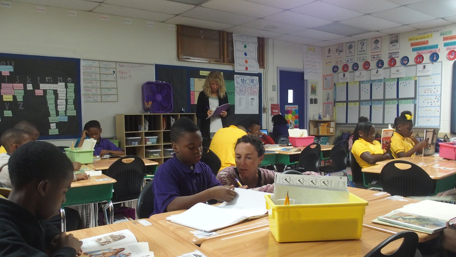 Aspire CEO Carolyn Hack talks with a student at Hanley 1 Elementary School during her tour of Aspire-operated charter schools in Memphis.