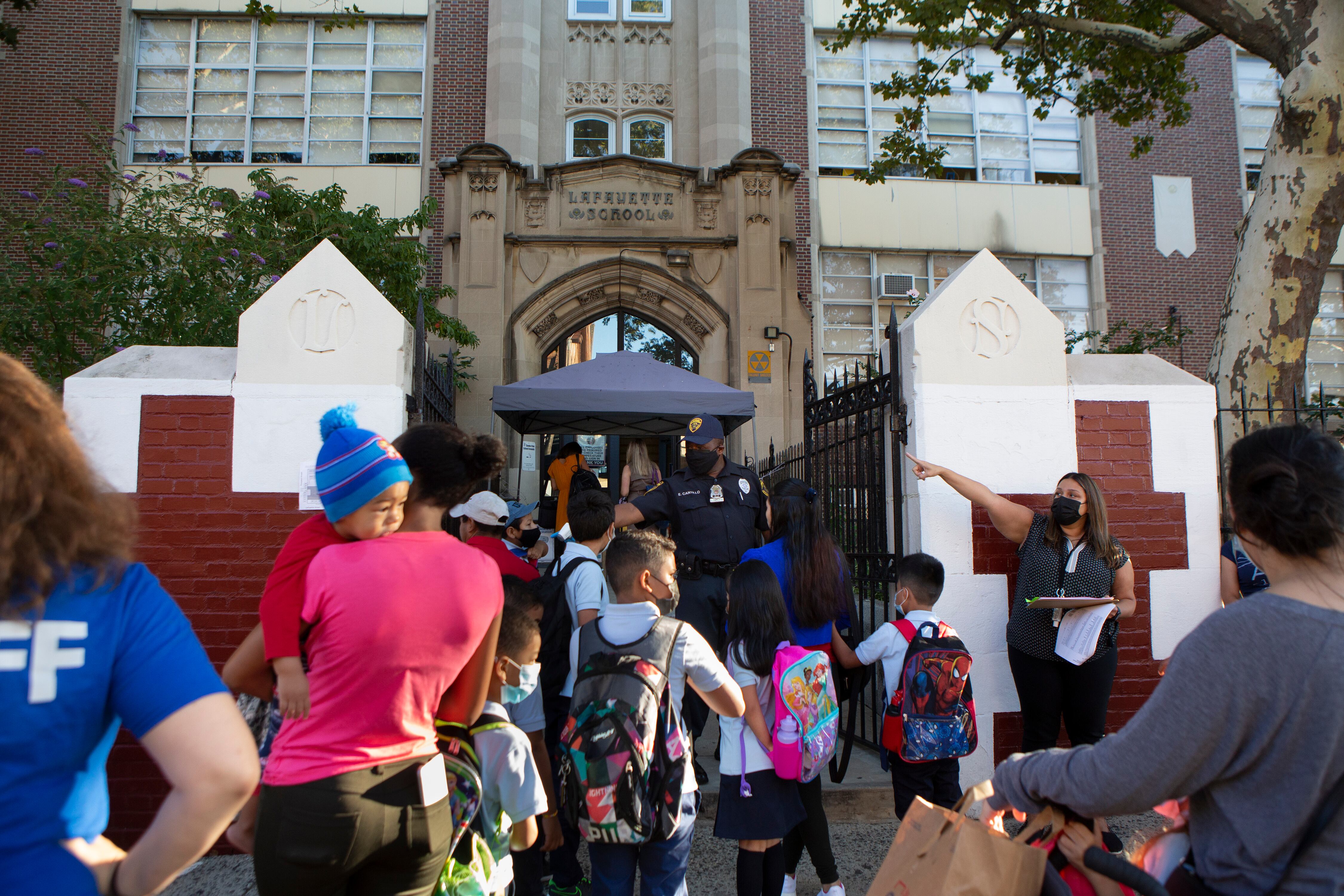 Several students and parents make their way into Newark’s Lafayette Street School on the first day of classes.